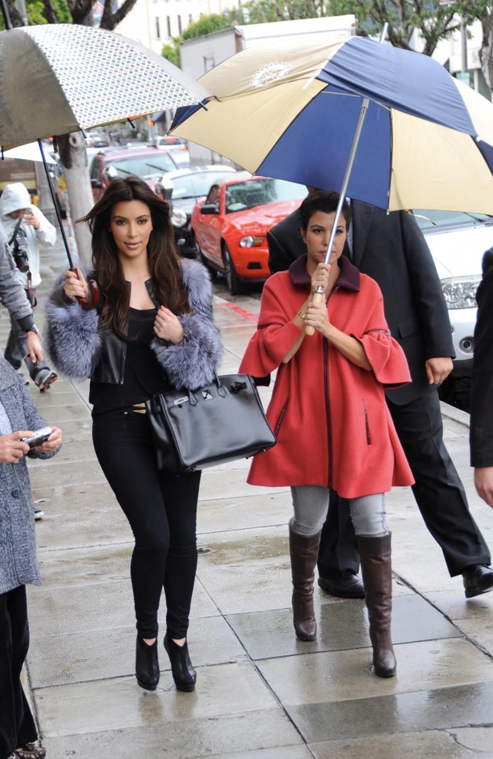 Kim and Kourtney Kardashian Brave the Rain in Beverly Hills